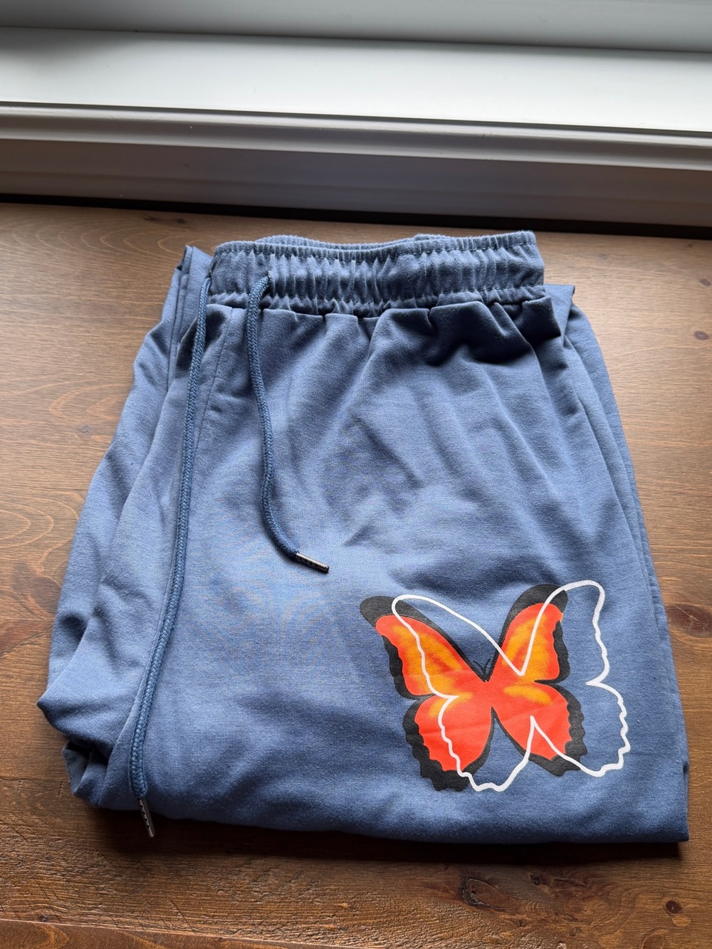 SHEIN Blue Sweatpants with Orange Butterfly Accent